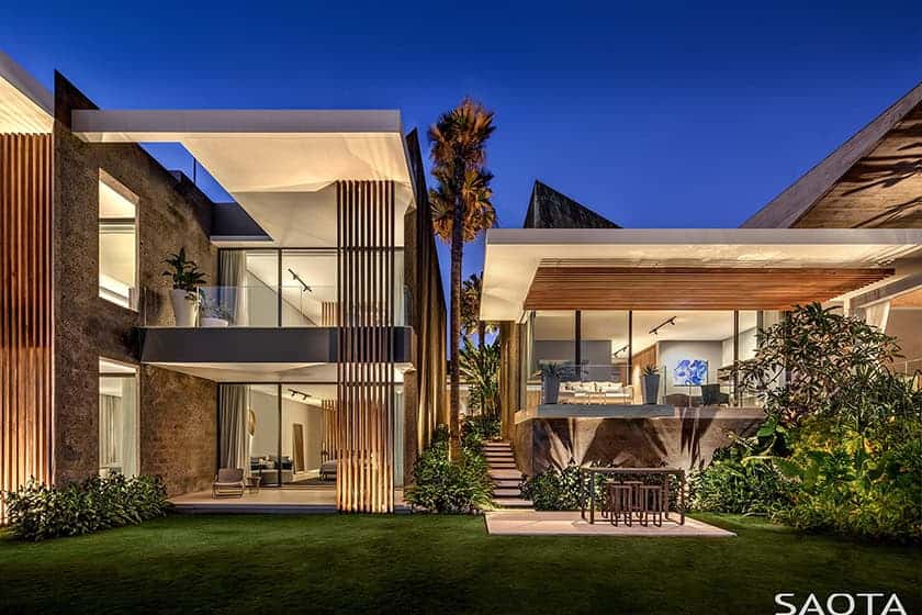 Luxury modern residential architecture with sleek design and open outdoor living spaces, featuring contemporary building materials and lush landscaping in a sunny setting.