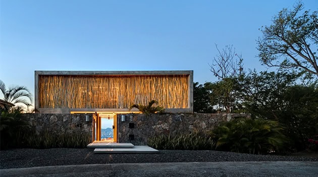 Minimalist modern house with striking geometric design and natural stone accents, perfect for contemporary architectural enthusiasts.