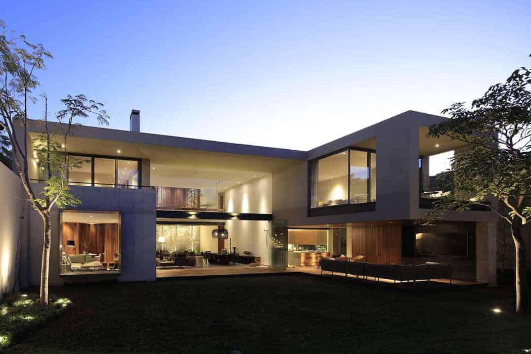 Modern contemporary house architecture showcasing sleek design, large glass windows, and outdoor lighting: Ideal for luxury residential architecture and stylish home designs.