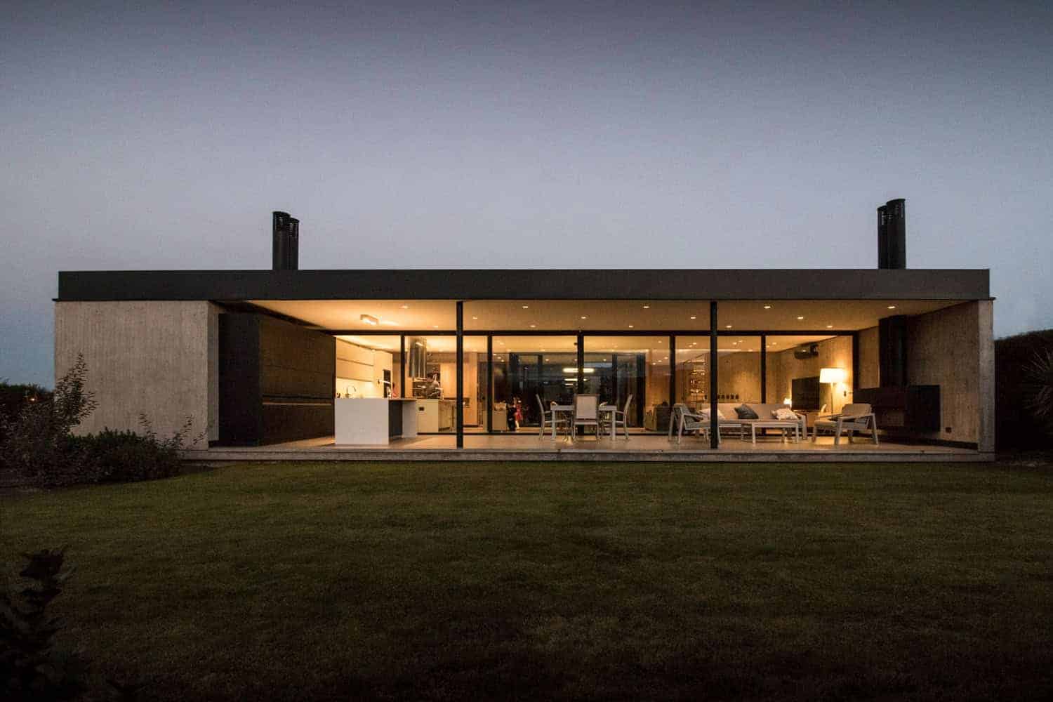 Contemporary minimalist house with open-plan living area, large glass windows, modern furnishings, and seamless indoor-outdoor connection, exuding sleek design and stylish architecture.