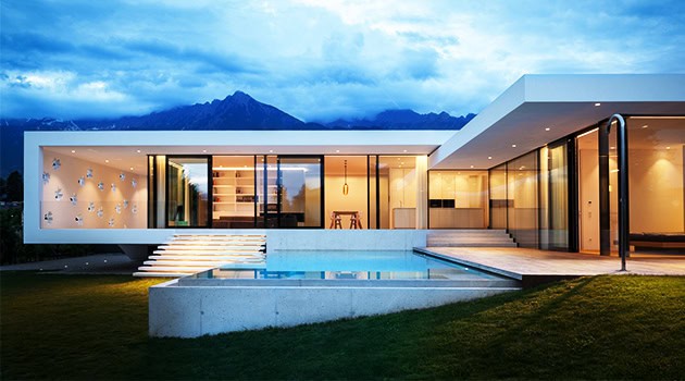 Modern luxury house with sleek contemporary architecture, large glass windows, and outdoor pool, set against mountain landscape, showcasing innovative residential design.
