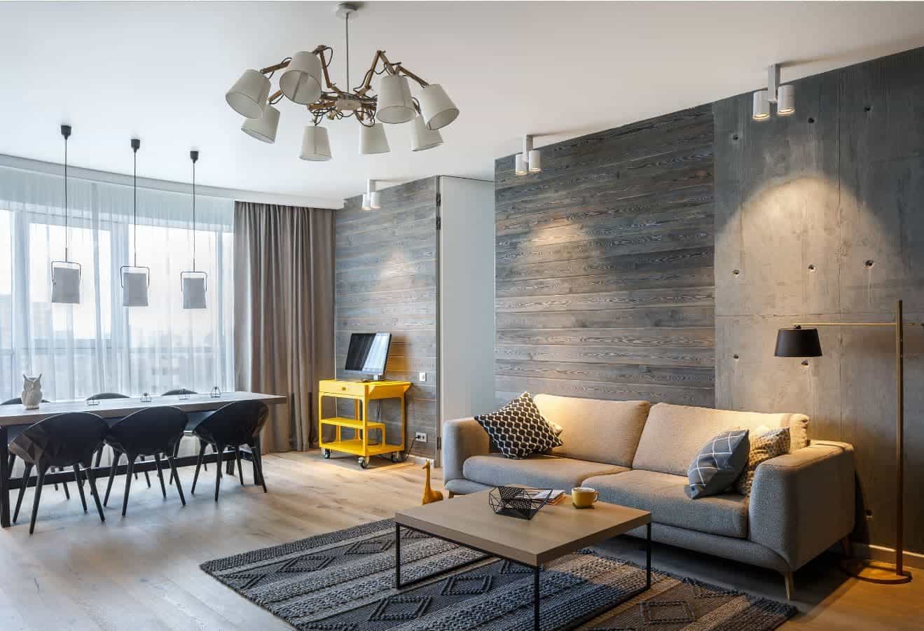 Contemporary living room interior with modern furniture, wooden accent wall, cozy sofa, stylish lighting, and natural light, showcasing minimalist design and creative space planning.