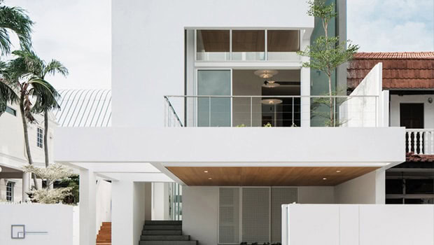 Modern minimalist white home facade with large glass balcony, clean lines, and contemporary architectural design.