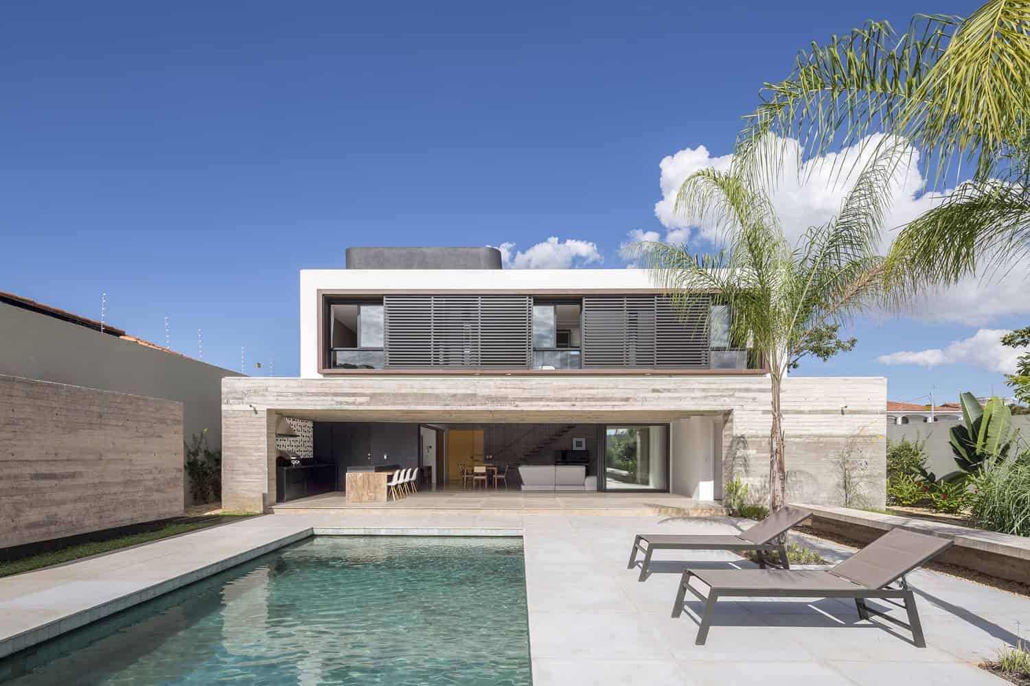 Modern luxury house with swimming pool, minimalist design, and contemporary architecture featuring clean lines and large glass windows.