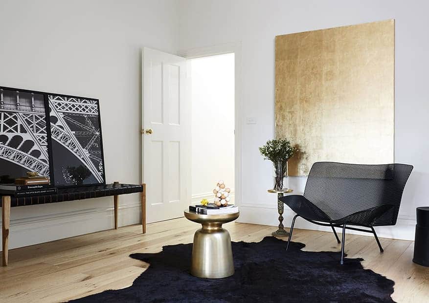 Elegant modern living room interior with minimalist design, contemporary artwork, and stylish furniture, emphasizing sleek decor, neutral tones, and sophisticated ambiance.