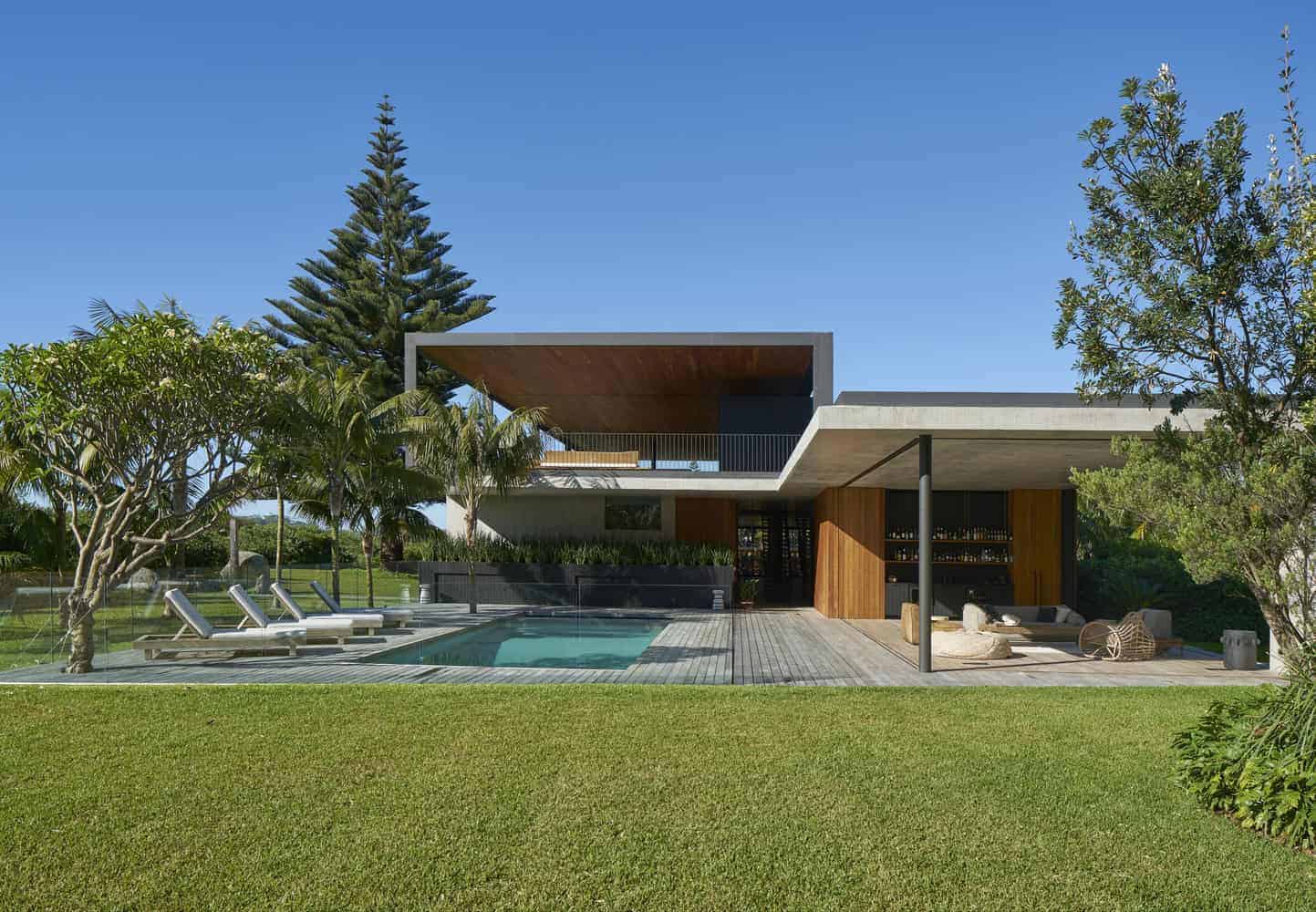 Contemporary modern house with sleek architectural design, outdoor pool, landscaped garden, and open living space, showcasing innovative architecture and stylish outdoor living areas.