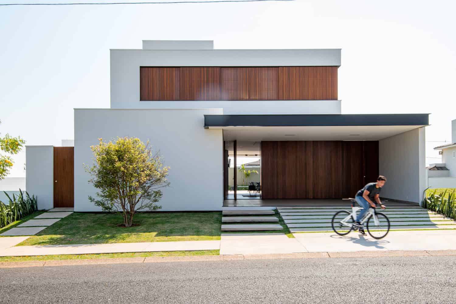 Contemporary minimalist modern house exterior with clean lines, white walls, and wooden accents showcasing sleek architectural design.