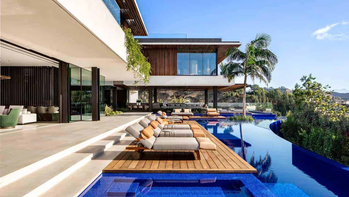 Modern luxury residential architecture with infinity pool, tropical landscaping, and contemporary design elements, perfect for upscale outdoor living and relaxation.