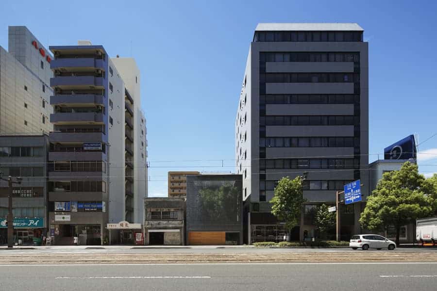Modern urban office buildings with sleek glass facades and contemporary architecture in a city street scene.