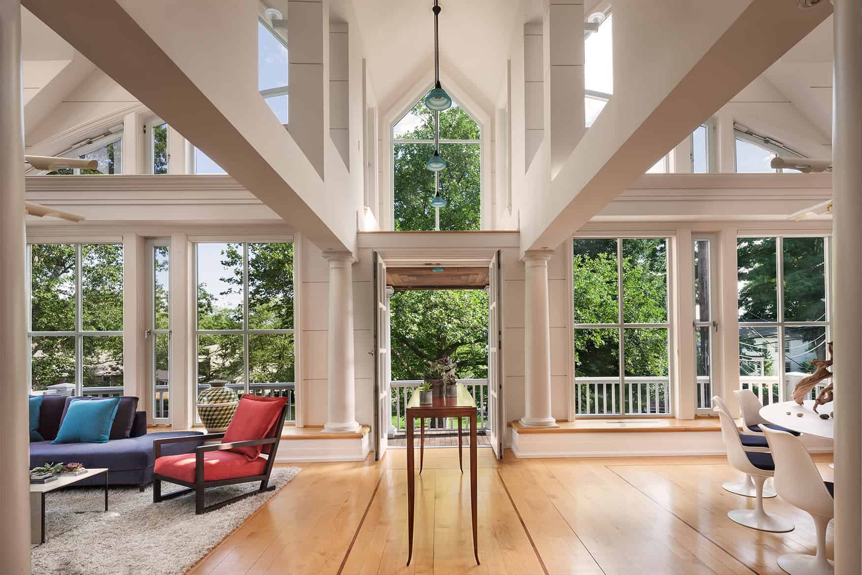 Bright spacious living room with large windows, high ceilings, and modern decor, showcasing contemporary architecture and interior design with natural light and stylish furniture.