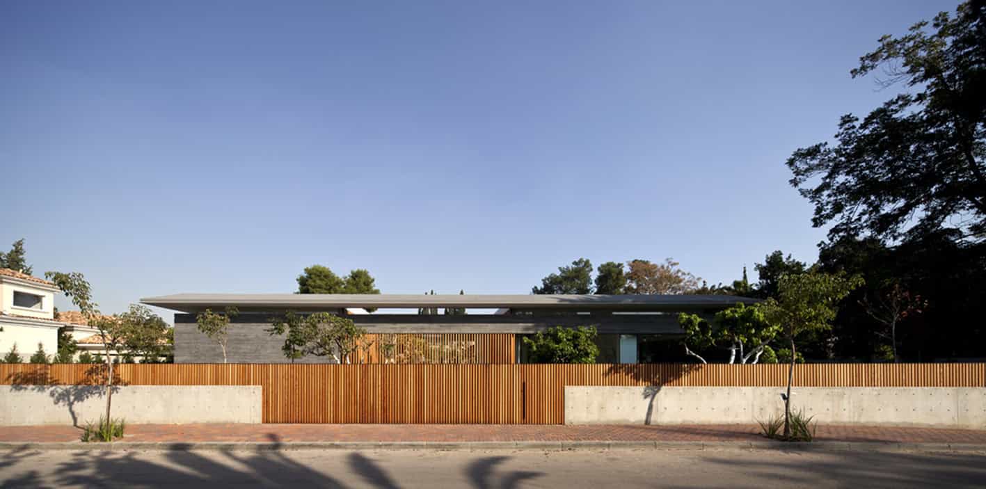 Contemporary modern house with flat roof and minimalist design, featuring sleek lines, natural wood accents, and surrounding greenery, showcasing innovative architecture art designs.