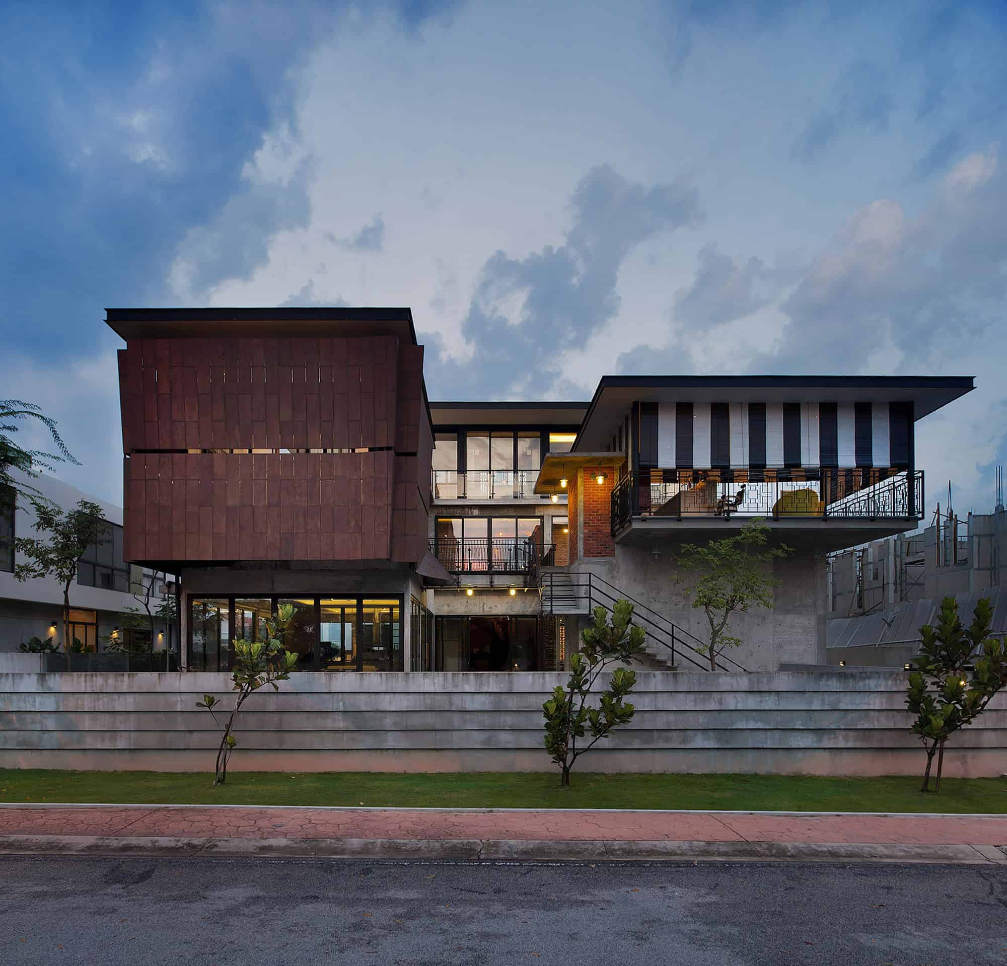 Contemporary modern house featuring unique architectural design, sharp angles, large glass windows, and mixed material facade, ideal for luxury home architecture and urban residential design.