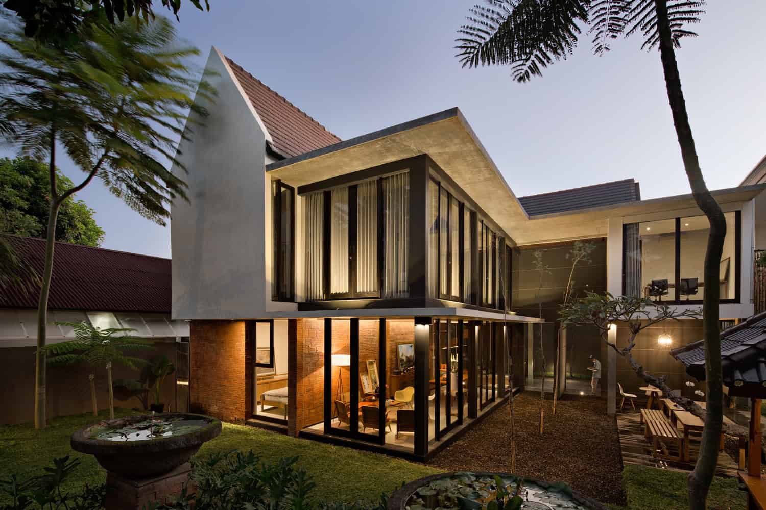 Modern contemporary house with large glass windows, sleek architectural design, and a landscaped yard, featuring minimalist style and innovative construction for luxury home design.