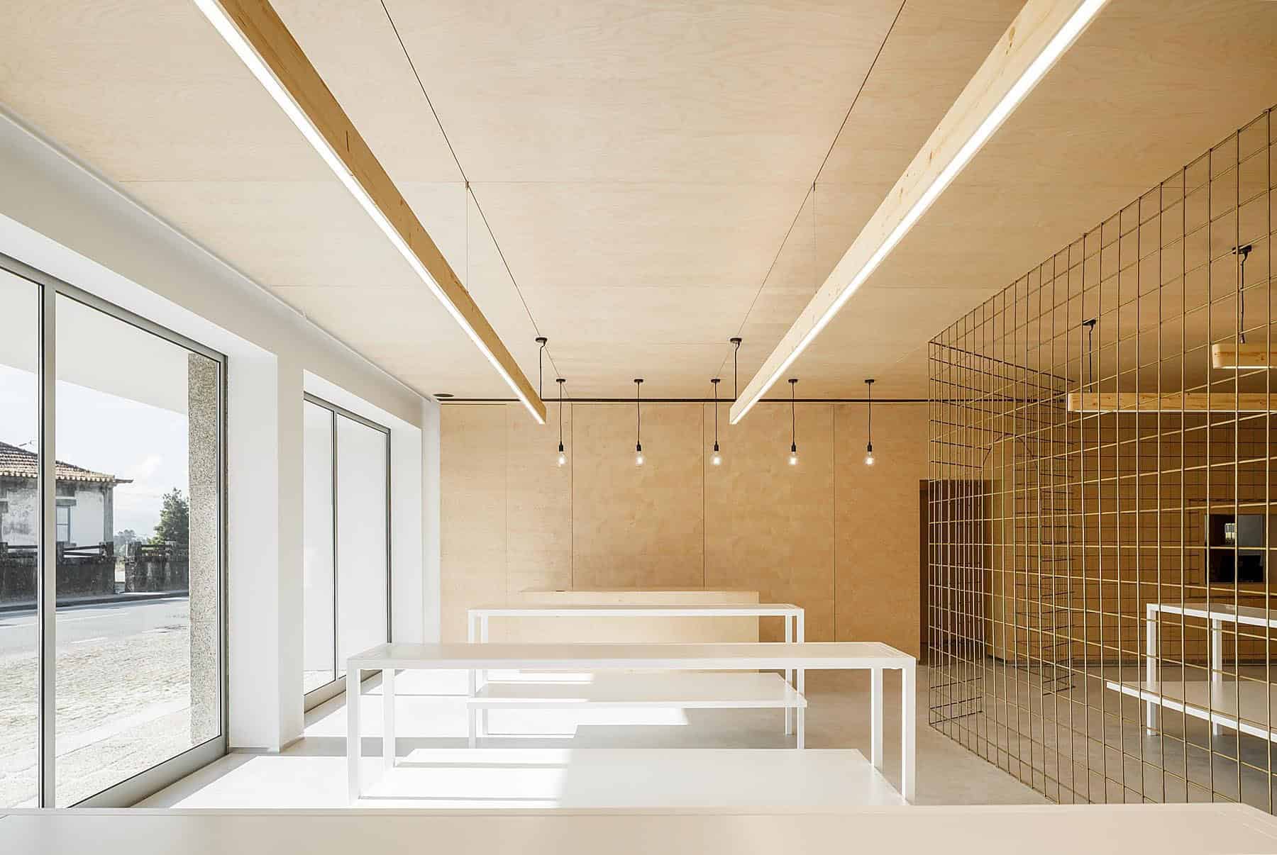 Contemporary minimalist interior design with clean lines, natural wood accents, and modern lighting fixtures in a bright, open space.