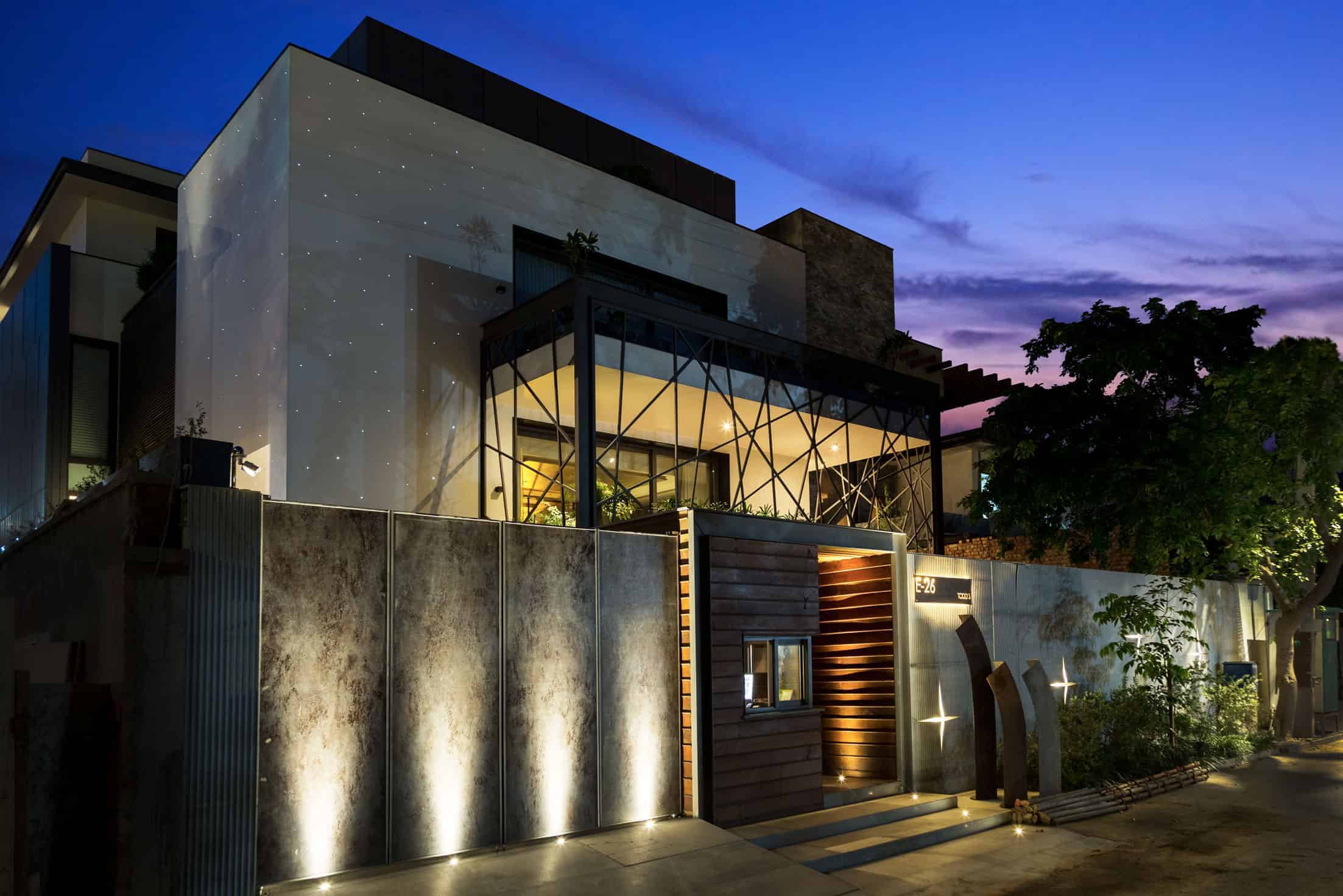 Contemporary modern house exterior design with sleek materials, innovative architecture, and stylish lighting at dusk, showcasing luxury residential architecture.