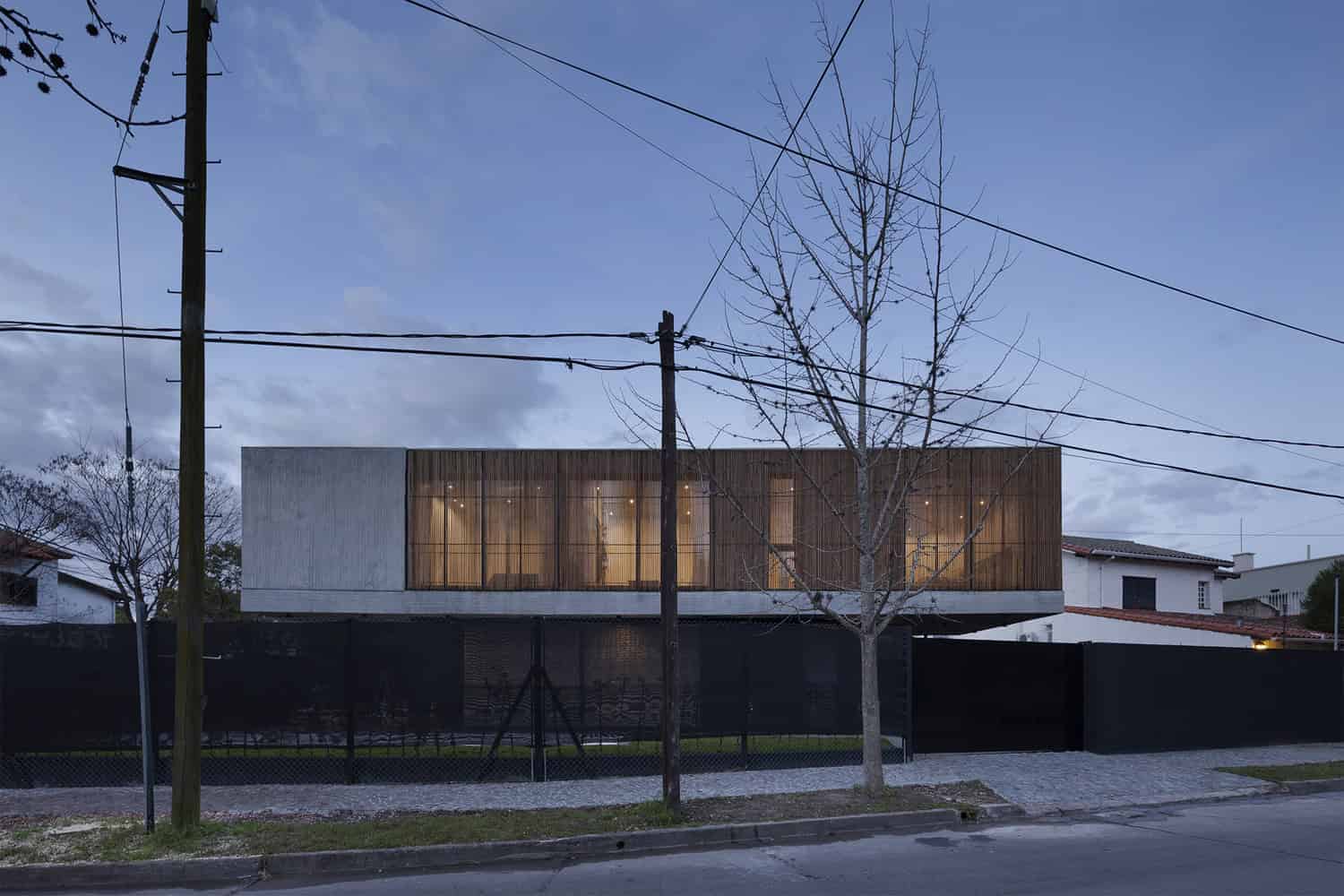 Contemporary modern house with minimalist design, wooden accents, large glass windows, and a sleek facade, showcasing innovative architecture and stylish residential architecture art designs.