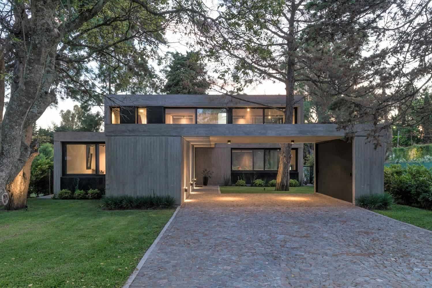 Contemporary modern house with sleek black exterior, large windows, and landscaped garden, showcasing minimalist architecture and stylish design.