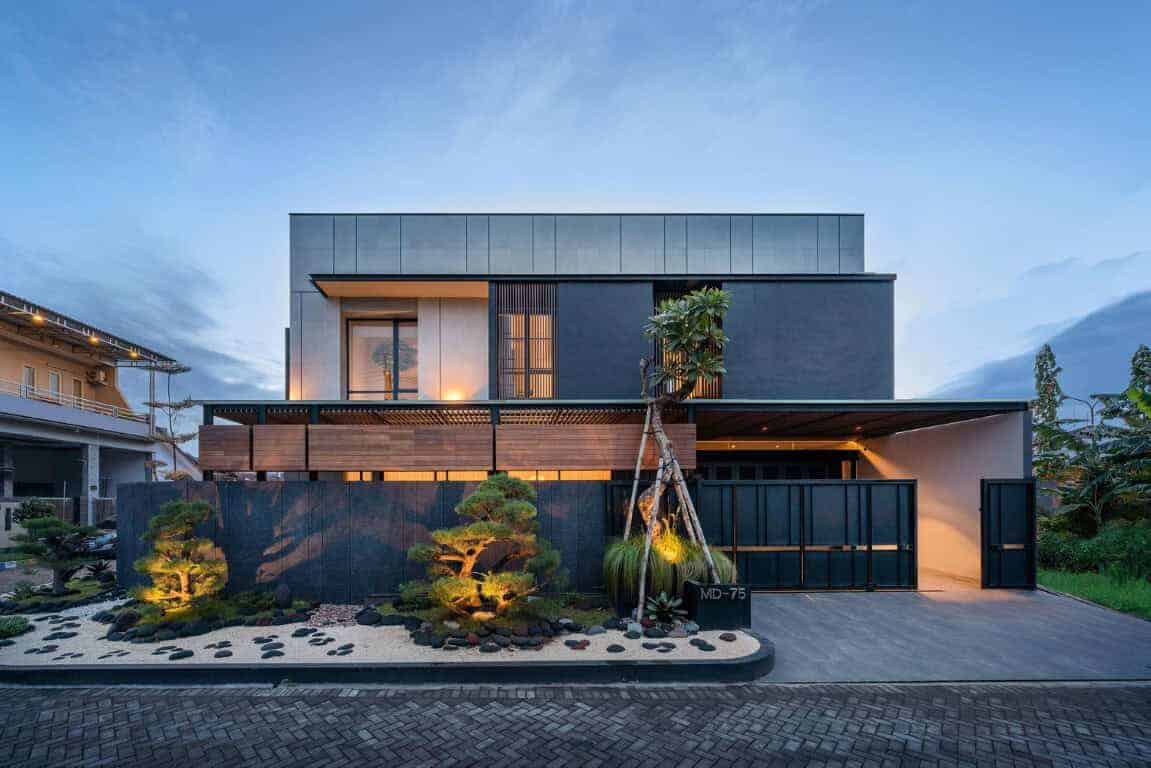 Modern minimalist house with sleek black and gray facade, contemporary architecture, illuminated landscape garden, and innovative design elements for luxury residential architecture.