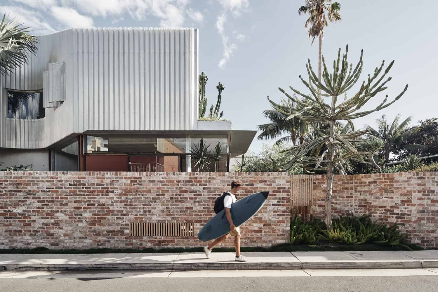 Contemporary architectural design with modern building facade and lush desert plants, featuring sleek lines and a minimalist aesthetic. Perfect for modern architecture and landscaping enthusiasts.
