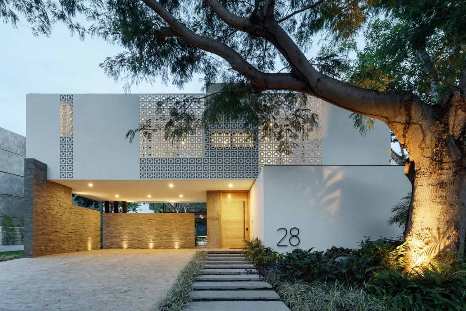 Contemporary modern house with minimalist design, clean lines, and innovative architecture, featuring a geometric facade and inviting entrance, perfect for modern architectural art and design enthusiasts.