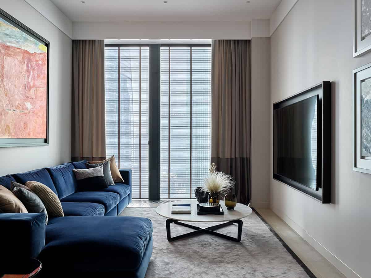 Contemporary living room interior with modern furniture, large window with blinds, elegant decor, and flat-screen TV – perfect example of modern architecture art designs.