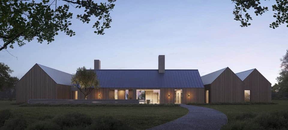 Contemporary modern farmhouse with sleek wooden exterior, metal roofs, and spacious outdoor patio, blending rustic charm with modern architectural design.