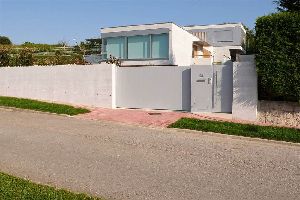 Modern minimalist house with clean lines and large windows, showcasing contemporary architecture and innovative design elements.