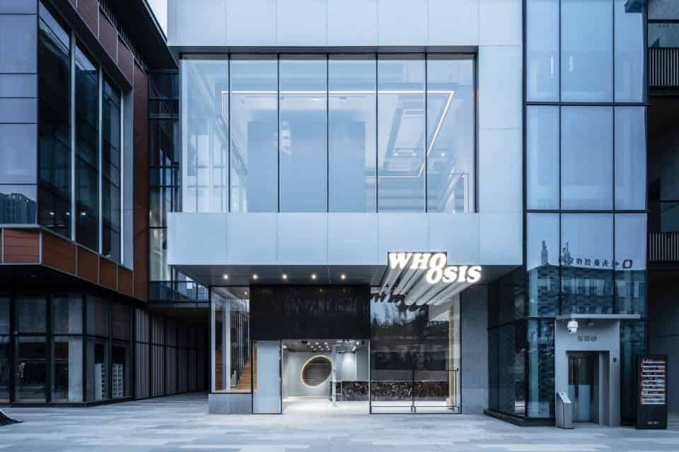 Futuristic modern commercial building with glass facade, innovative architectural design, and sleek exterior features, showcasing contemporary urban architecture and stylish storefronts.