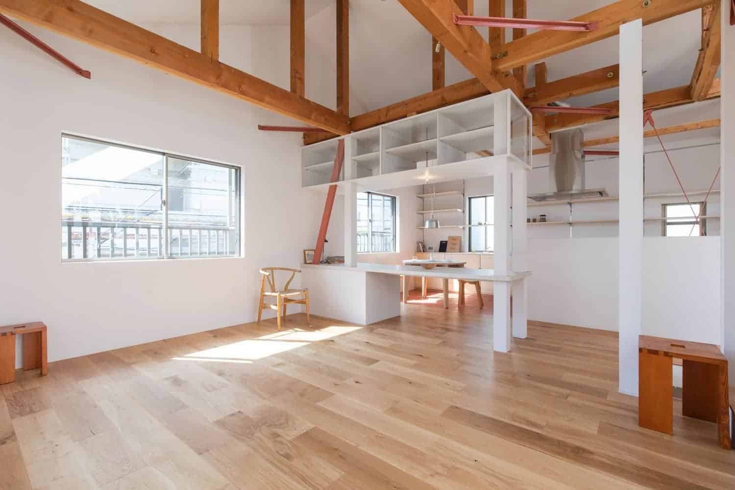 Modern minimalist interior with natural wood accents, open-plan living space, and bright sunlight. Showcasing contemporary home design, wooden beams, and airy atmosphere.