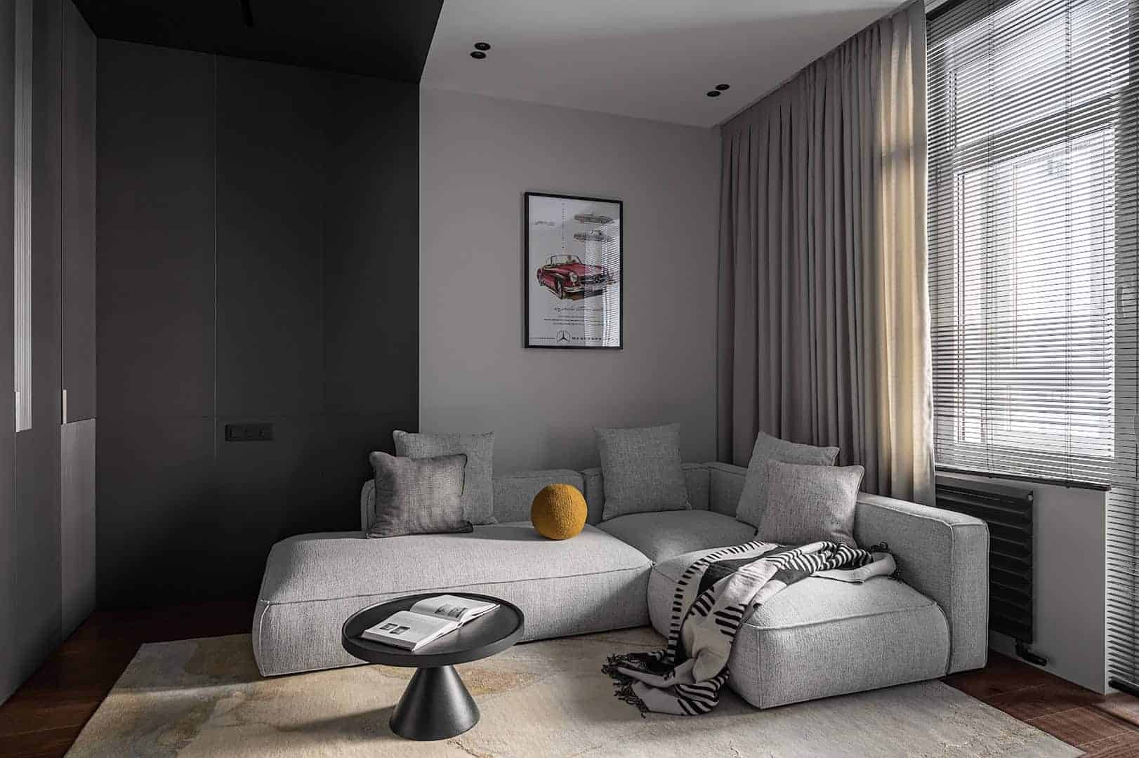 Minimalist living room with neutral-toned sectional sofa, large window with elegant curtains, and modern decor emphasizing contemporary architecture and interior design.