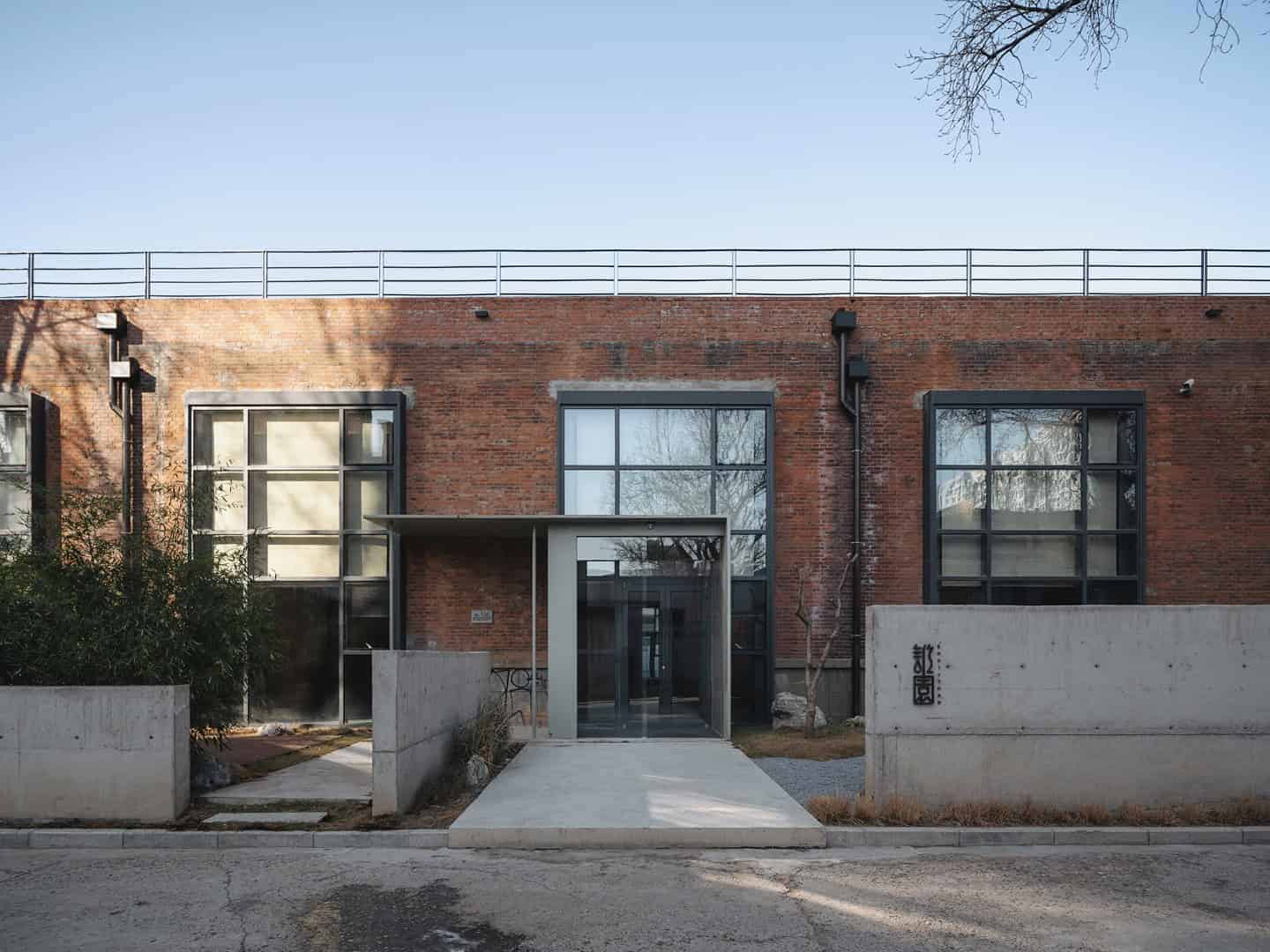 Contemporary brick residential building with modern glass features and minimalist design, showcasing innovative architecture and urban residential style.
