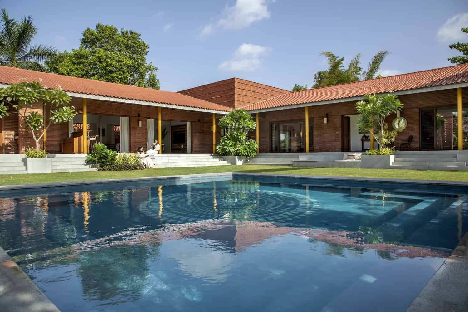 Modern tropical villa with a swimming pool, showcasing contemporary architecture and outdoor living space, surrounded by lush greenery and designed for luxury and comfort.
