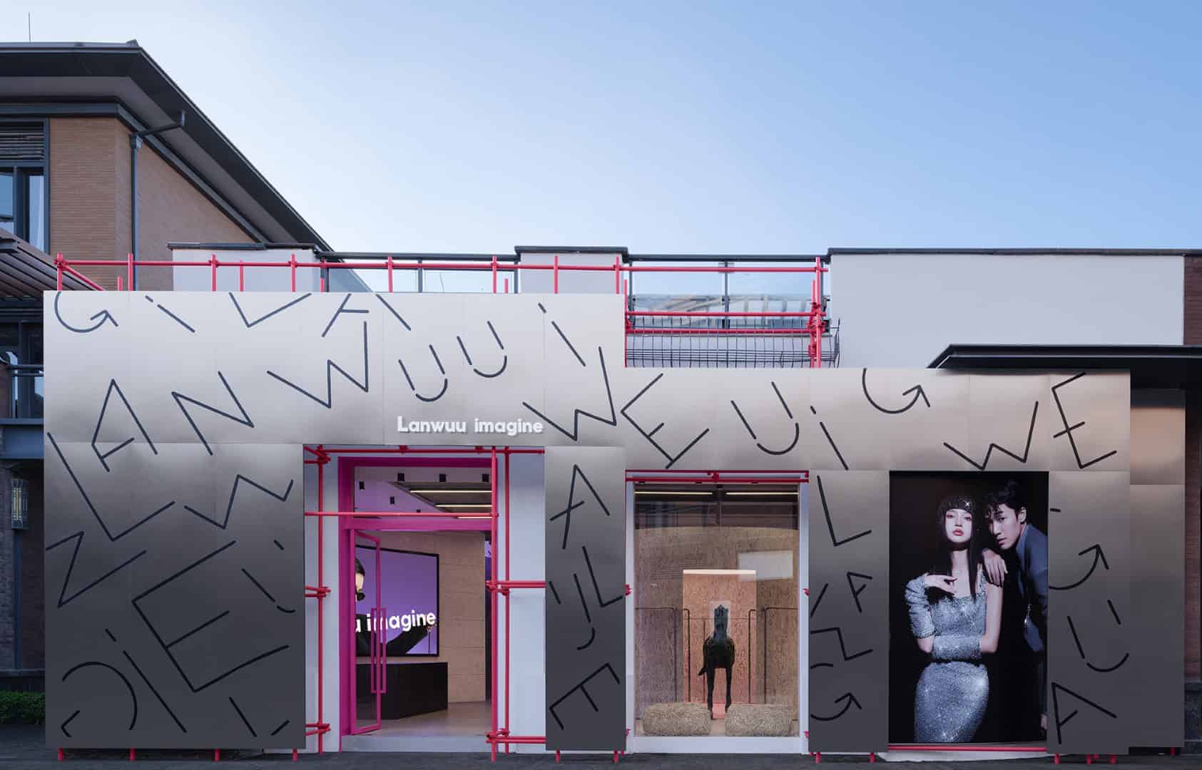 Modern architectural design of a trendy pop-up retail space with bold graphic elements and vibrant pink accents, featuring innovative construction and eye-catching aesthetics for urban commercial environments.