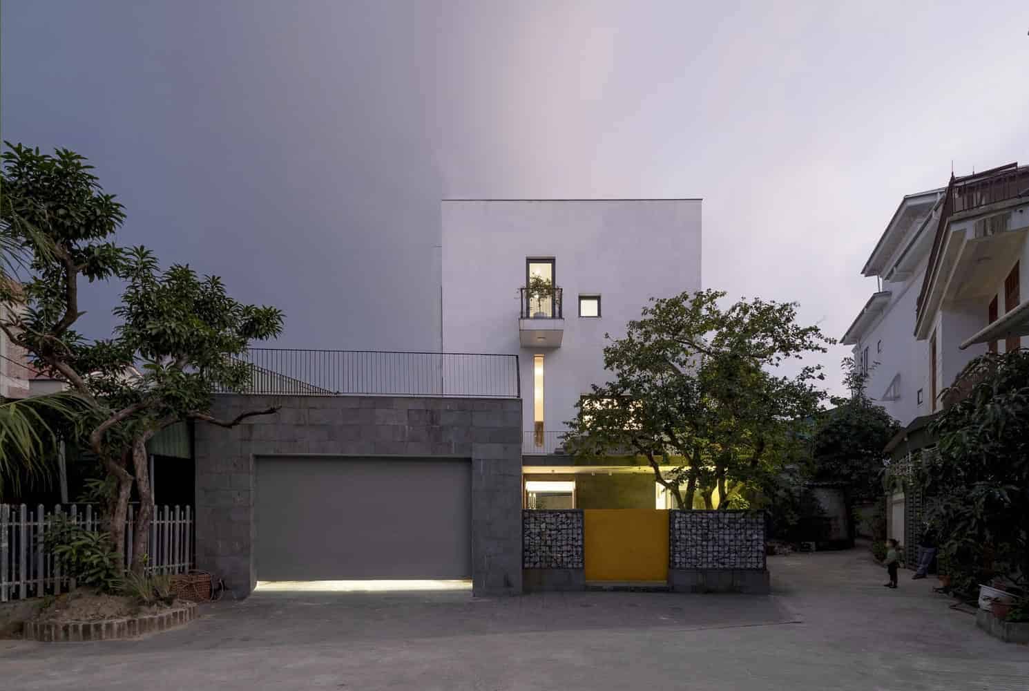 Contemporary minimalist house with clean white facade, modern architectural design, and urban landscape. Features include geometric shapes, large windows, and stylish outdoor elements.