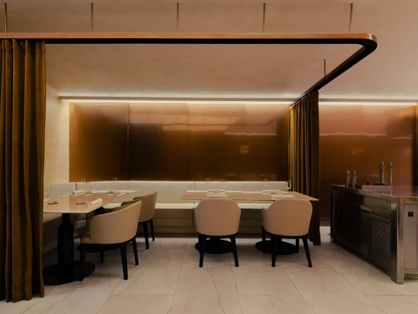 Elegant modern restaurant interior with minimalist design, soft lighting, neutral tones, and sophisticated furniture for contemporary dining experience.