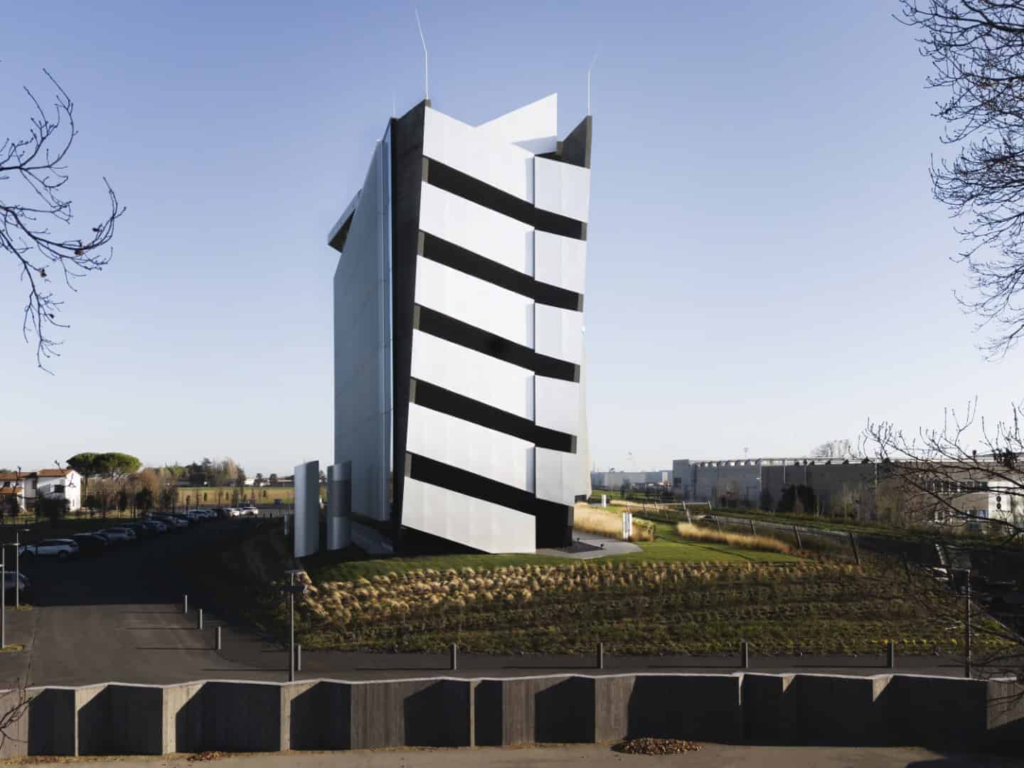 Futuristic black and white modern skyscraper with angular design in a corporate office district.