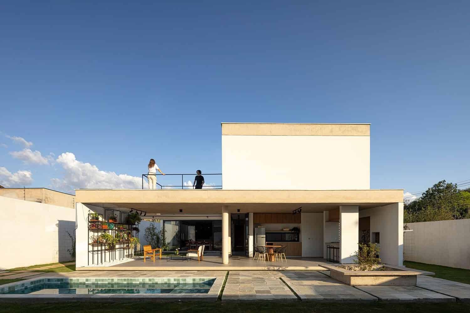 Modern minimalist house with outdoor living space, pool, and rooftop terrace, featuring sleek architectural design and contemporary decor, perfect for luxury residential architecture.