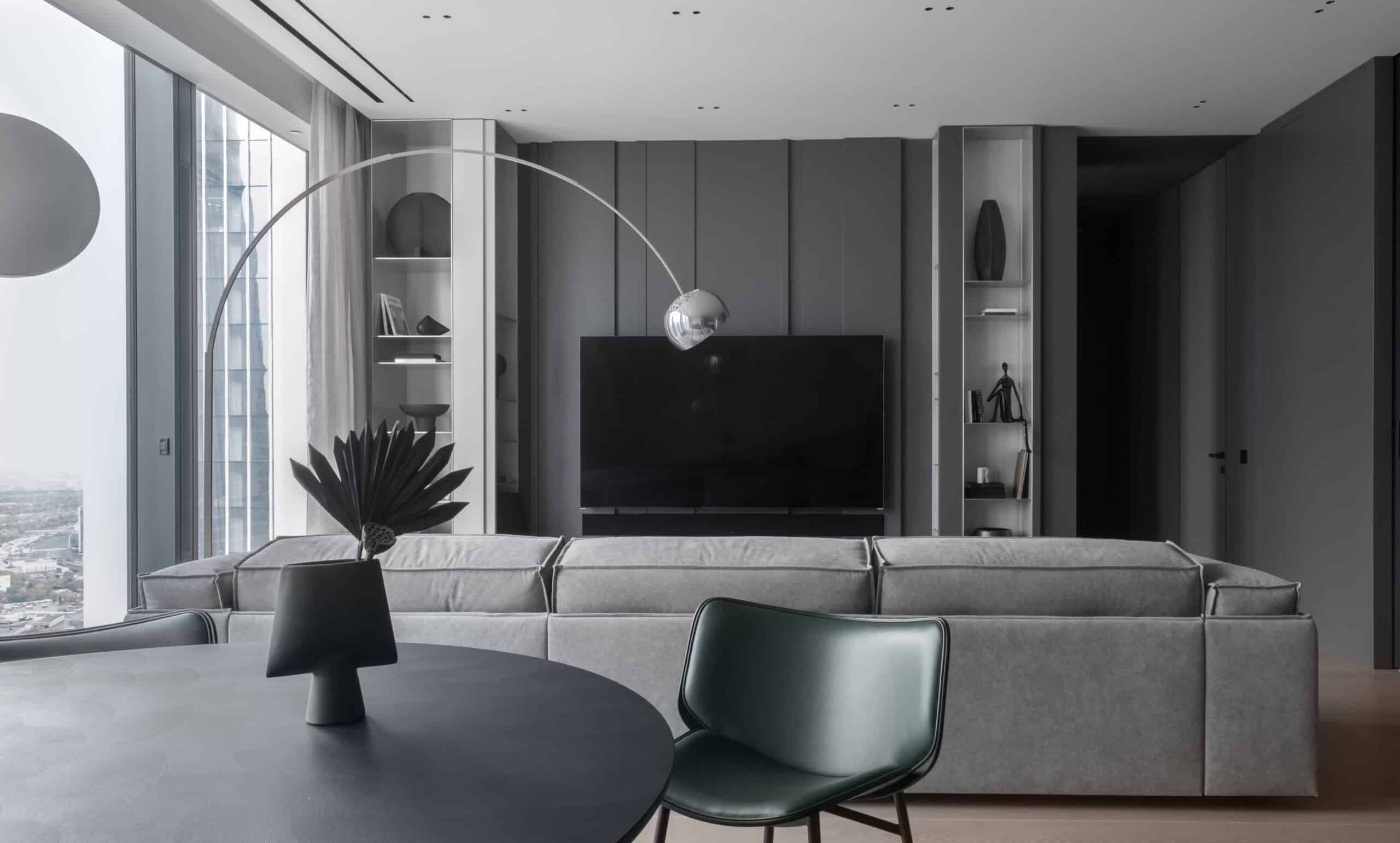 Contemporary minimalist living room with sleek furniture and floor-to-ceiling windows, featuring modern design and interior decor, emphasizing modern architecture and stylish home interior design.