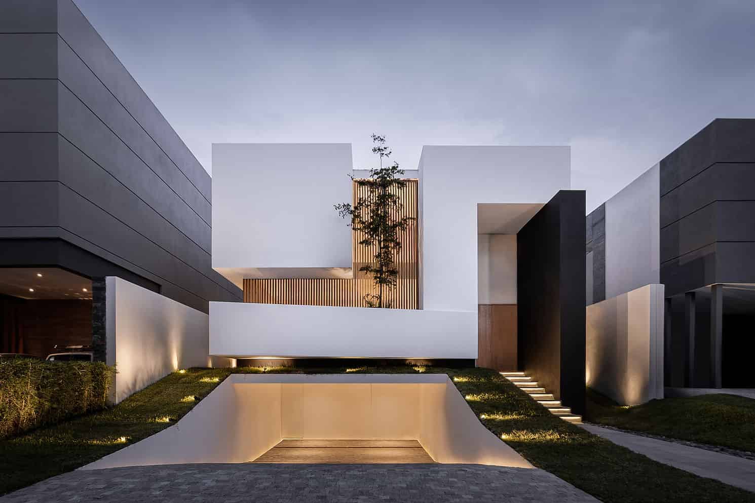 Sleek modern house facade with minimalist architectural design featuring clean lines and contrasting dark and white exterior colors.