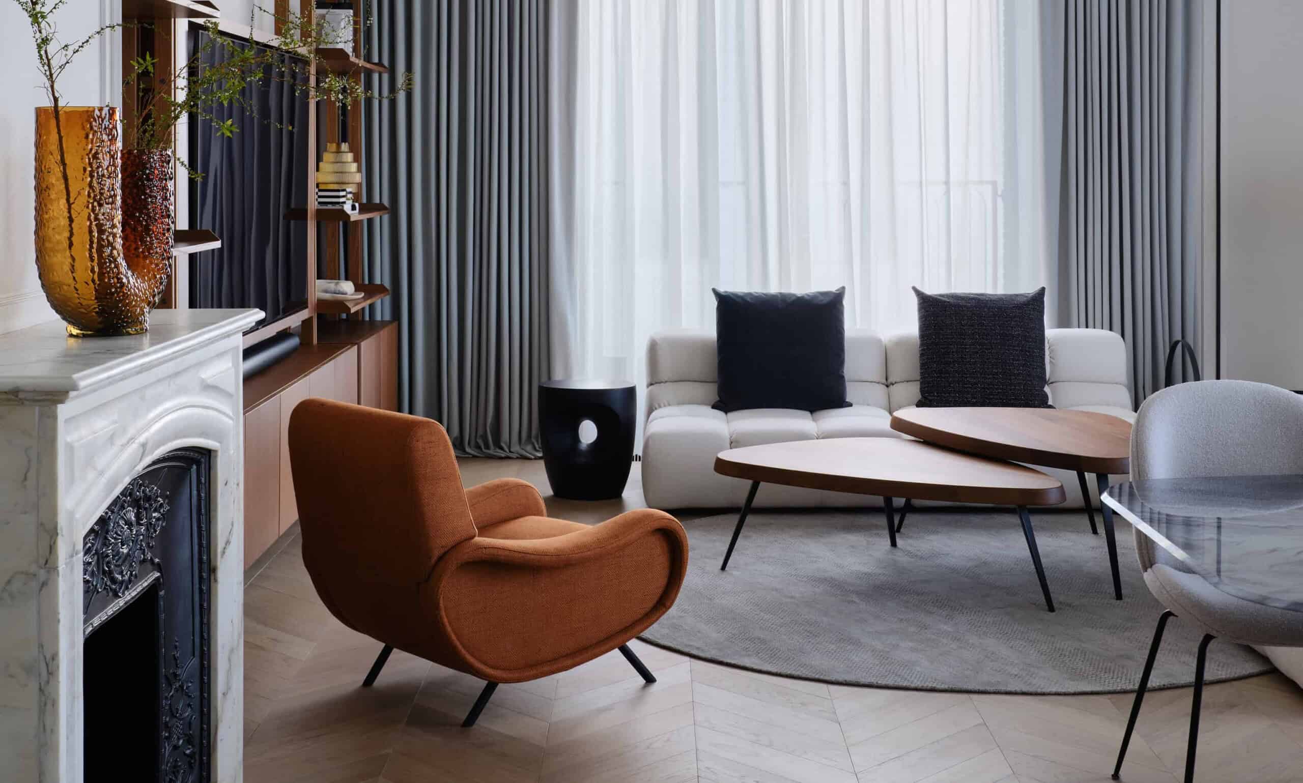 Elegant modern living room with contemporary furniture, cozy armchair, and stylish drapery featuring sleek interior design elements.