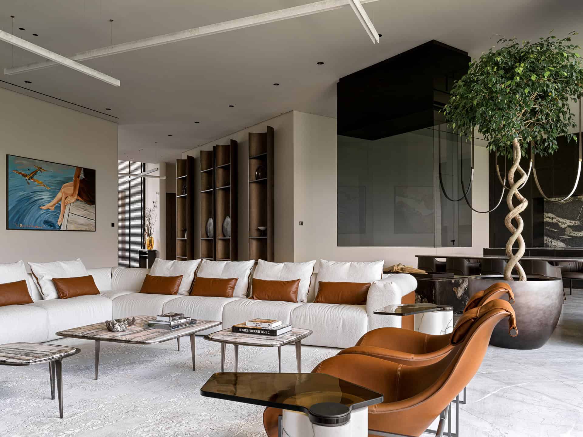 Contemporary modern living room interior with stylish furniture, large white sectional sofa, leather armchairs, minimalist decor, and natural lighting, showcasing luxury home architecture and interior design.