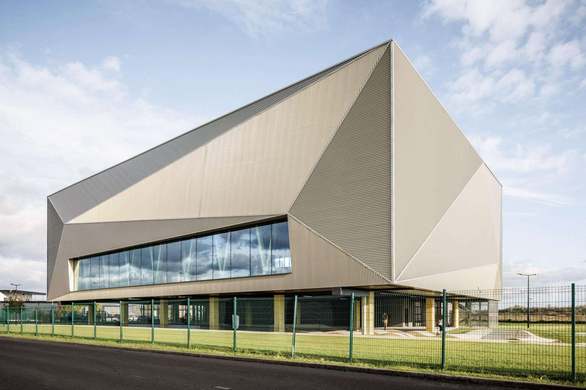 Futuristic modern architecture building with geometric design and sleek metallic exterior.