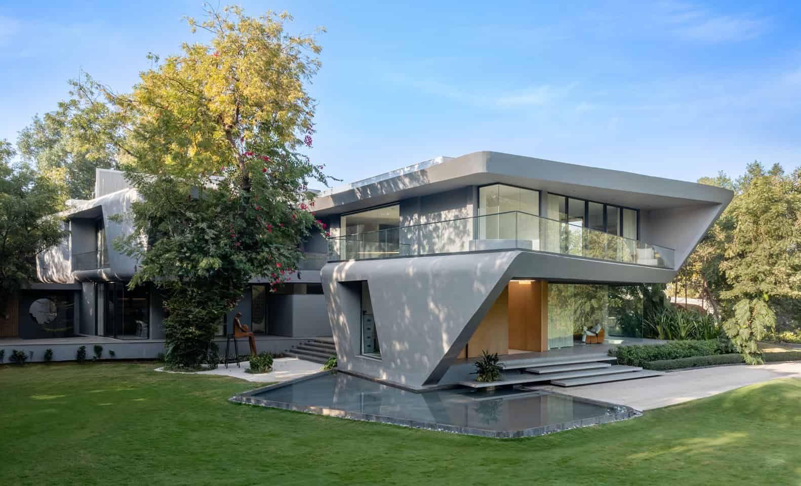 Contemporary modern house with sleek architectural design, large glass windows, and lush landscaping, showcasing innovative architecture art and modern residential home styling.