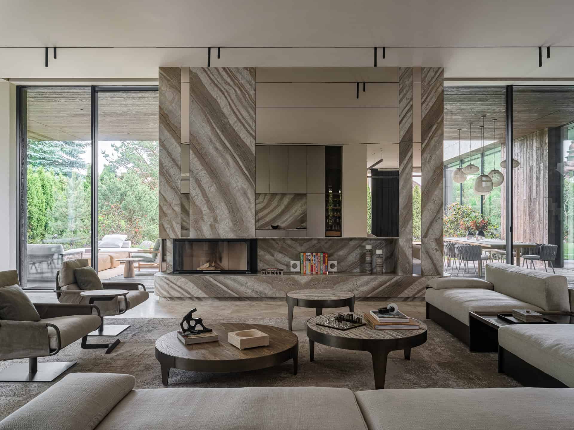 Luxurious modern living room with natural stone finishing, large glass windows overlooking lush greenery, contemporary furniture, and open dining area, showcasing innovative architectural design and stylish interior decor.