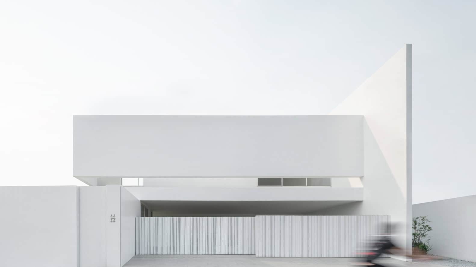 Modern minimalist white architectural house with clean lines and geometric design, showcasing contemporary building architecture, ideal for architectural art designs.