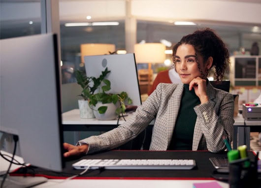 stock image woman in office at computer desk