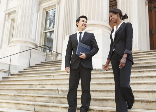 stock image man and woman talking on government building steps