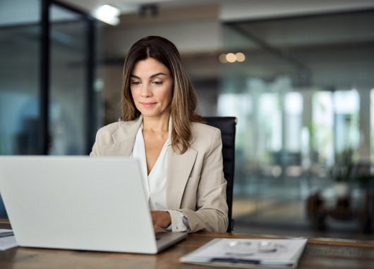 stock image businesswoman at laptop