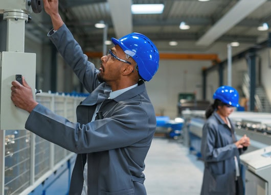 stock image man and woman working in facility