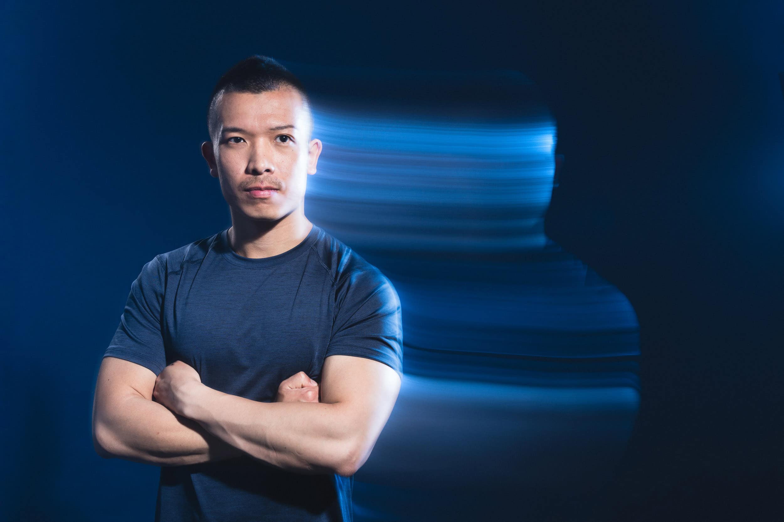 dynamic-portrait-of-asian-male-with-blue-light-trails